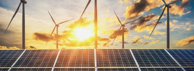 wind turbine with solar panels and sunset. concept clean energy