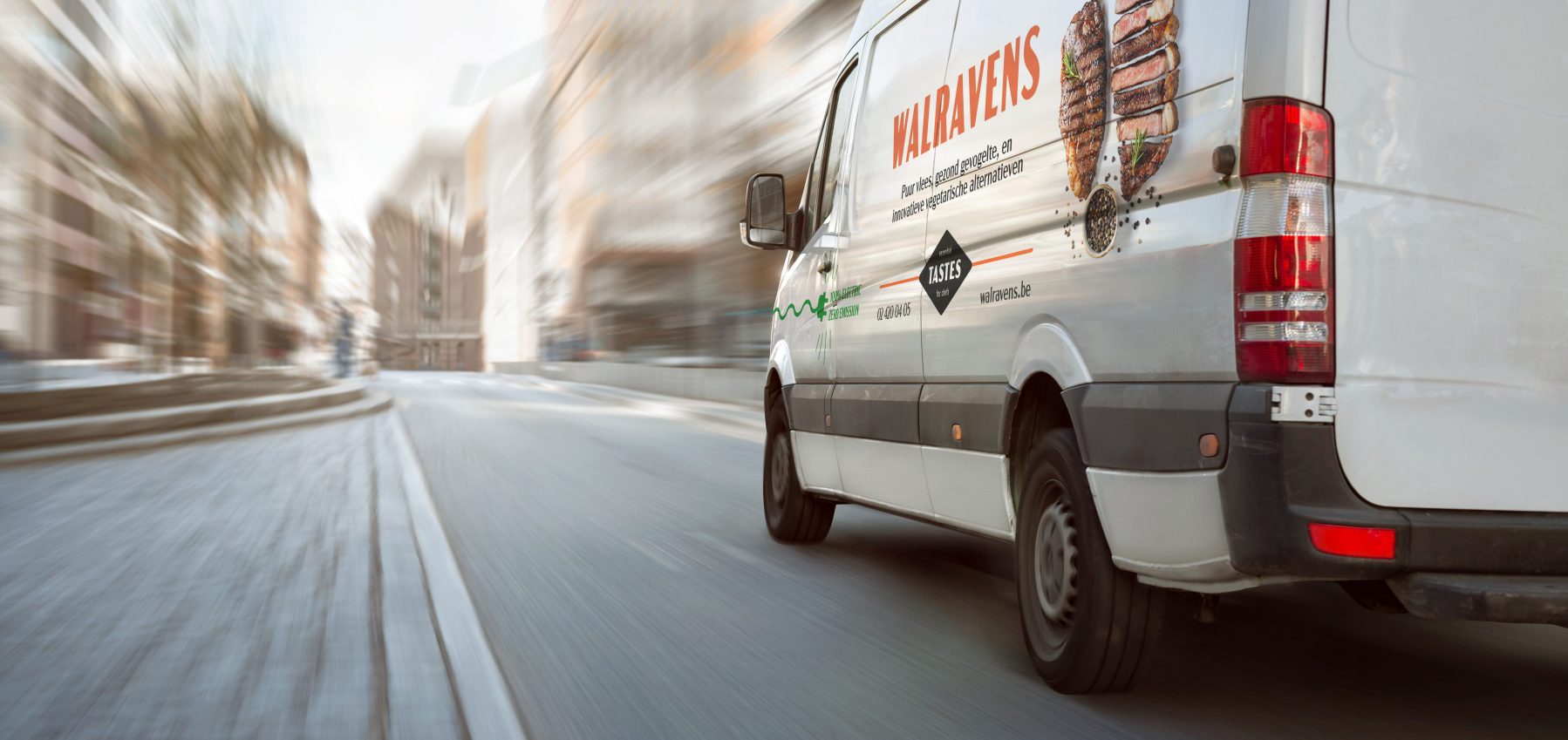White transporter driving inside the city