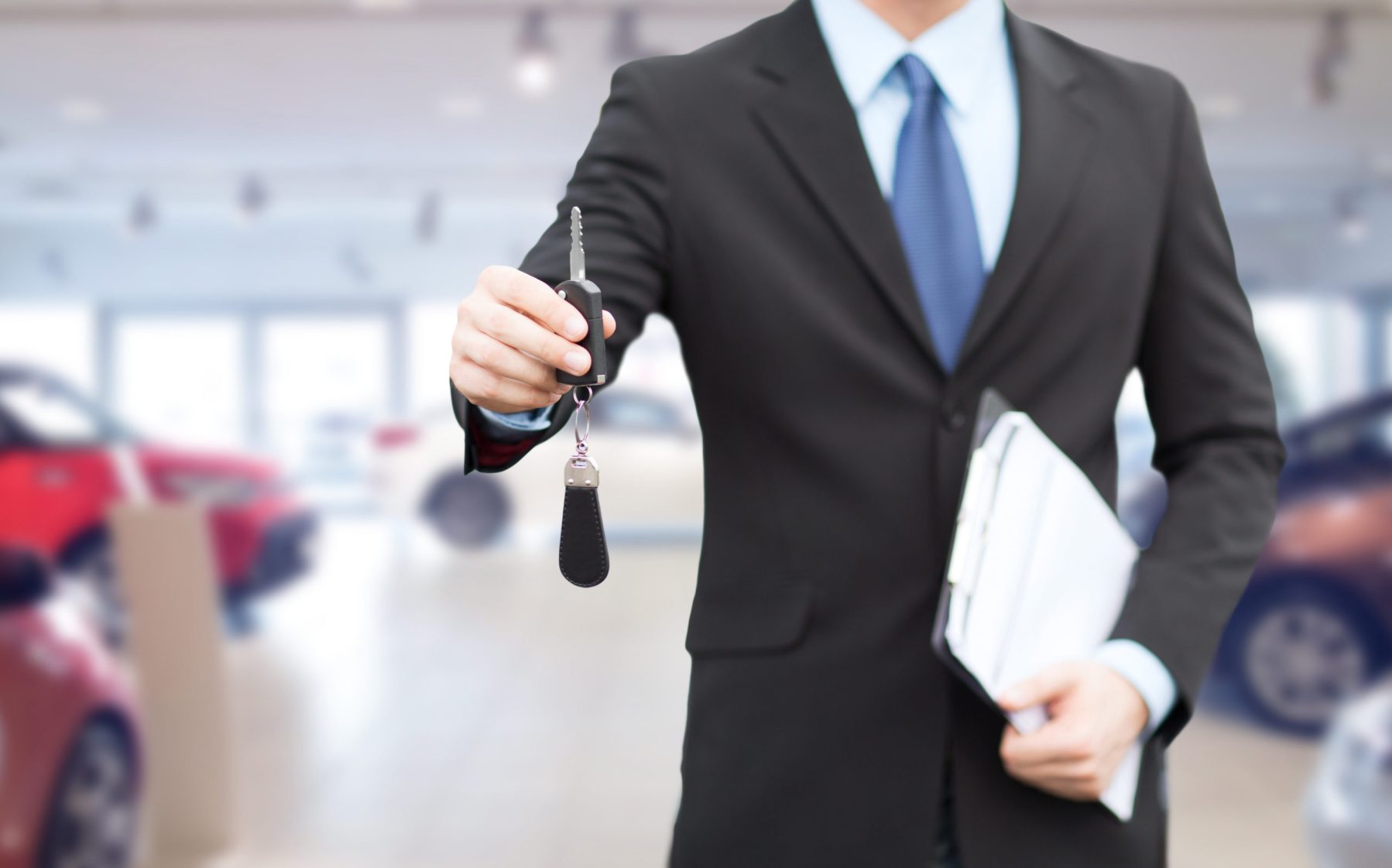 close up of businessman or salesman giving car key